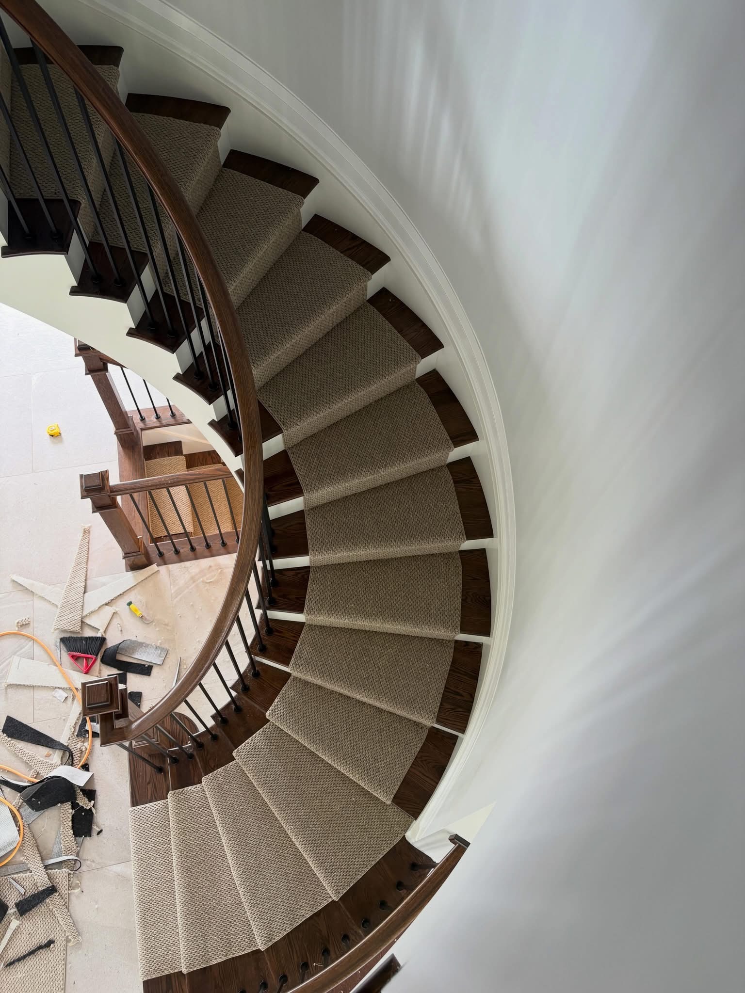 Curved staircase carpet installation viewed from above